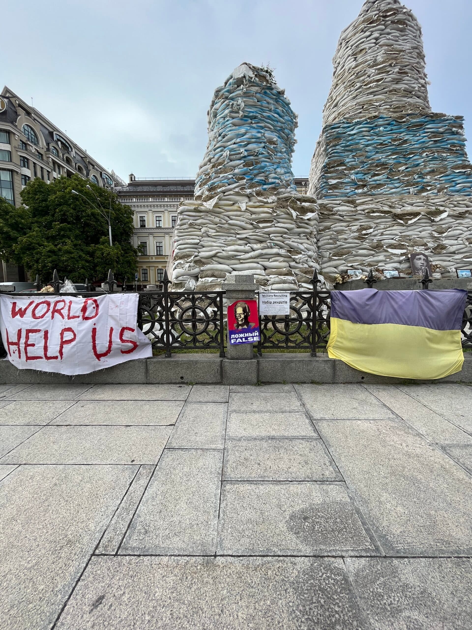 Protest posters and signs mounted on a fence